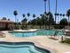 Community pool and spa with lounge chairs and landscaping at 11111 E Elmhurst Dr, Sun Lakes, AZ 85248