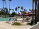 Resort-style pool with lounge chairs and palm trees at 11111 E Elmhurst Dr, Sun Lakes, AZ 85248