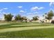 Community putting green with people enjoying the course at 11111 E Elmhurst Dr, Sun Lakes, AZ 85248