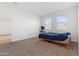 Well lit bedroom with carpet, and access to another room at 1130 W Avalon Canyon Dr, Casa Grande, AZ 85122