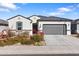 Newly built home with gray garage door and desert landscaping at 1130 W Avalon Canyon Dr, Casa Grande, AZ 85122