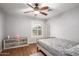 Cozy bedroom with wood floors and a window with shutters at 1201 E Campbell Ave, Gilbert, AZ 85234