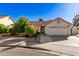 Single-story home with red tile roof, two-car garage, and mature landscaping at 1201 E Campbell Ave, Gilbert, AZ 85234