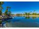 Scenic community lake with a waterfall feature and palm trees at 1201 E Campbell Ave, Gilbert, AZ 85234