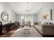 Bright living room featuring hardwood floors, comfy seating, and large windows at 1201 E Campbell Ave, Gilbert, AZ 85234