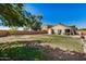 Large backyard with grassy area and patio at 12443 W Via Camille Dr, El Mirage, AZ 85335