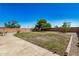 Large backyard with patio and grassy area at 12443 W Via Camille Dr, El Mirage, AZ 85335