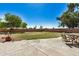 Spacious backyard with grassy area and patio at 12443 W Via Camille Dr, El Mirage, AZ 85335