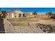 Backyard with grassy area, patio, and shed at 12443 W Via Camille Dr, El Mirage, AZ 85335