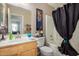 Simple bathroom with tub, shower, and wood vanity at 12443 W Via Camille Dr, El Mirage, AZ 85335