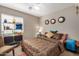 Bright bedroom with a queen-size bed and built-in shelving at 12443 W Via Camille Dr, El Mirage, AZ 85335