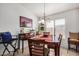 Cozy dining area with a wood table and four chairs at 12443 W Via Camille Dr, El Mirage, AZ 85335