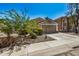 Tan house with a two-car garage and small front yard at 12443 W Via Camille Dr, El Mirage, AZ 85335