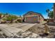 Tan house with a two-car garage and fire hydrant at 12443 W Via Camille Dr, El Mirage, AZ 85335