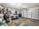 Attached garage with ample storage space and shelving at 12443 W Via Camille Dr, El Mirage, AZ 85335