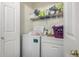 Convenient laundry room with washer, dryer, and shelving at 12443 W Via Camille Dr, El Mirage, AZ 85335