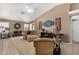 Spacious living room featuring a ceiling fan and large artwork at 12443 W Via Camille Dr, El Mirage, AZ 85335