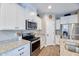 Bright kitchen featuring white cabinets and granite countertops at 1255 N Arizona Ave # 1148, Chandler, AZ 85225