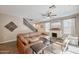 Living area featuring a brown leather sectional and a staircase at 1255 N Arizona Ave # 1148, Chandler, AZ 85225