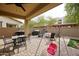 Covered patio with outdoor dining set, grill, and swing at 1255 N Arizona Ave # 1148, Chandler, AZ 85225