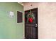 Condo entrance with green walls and a holiday wreath at 1295 N Ash St # 913, Gilbert, AZ 85233