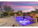 Stunning backyard with a sparkling pool, fire pit, and built-in seating at 13213 W Duane Ln, Peoria, AZ 85383