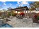 Covered patio with dining area, fire pit, and built-in grill at 13213 W Duane Ln, Peoria, AZ 85383