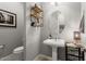 Modern powder room with pedestal sink and floating shelves at 13213 W Duane Ln, Peoria, AZ 85383