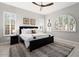 Serene bedroom with a wooden bed frame and plenty of natural light from an arched window at 13213 W Duane Ln, Peoria, AZ 85383