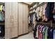 Large walk-in closet with ample shelving and hanging space for clothes at 13213 W Duane Ln, Peoria, AZ 85383