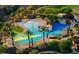 Large community pool complex with multiple pools and shade structures at 13213 W Duane Ln, Peoria, AZ 85383