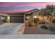 Single-story home with a two-car garage and desert landscaping at 13213 W Duane Ln, Peoria, AZ 85383