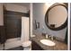 Clean bathroom with dark tile, granite vanity, and a shower/tub combo at 14235 E Dale Ln, Scottsdale, AZ 85262