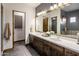 Elegant bathroom with double vanity, large mirror, and separate shower at 14235 E Dale Ln, Scottsdale, AZ 85262