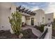 Inviting front porch with pergola and desert landscaping at 14235 E Dale Ln, Scottsdale, AZ 85262