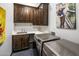 Laundry room with ample cabinet space and modern appliances at 14235 E Dale Ln, Scottsdale, AZ 85262