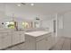 Bright kitchen with island, white cabinets, and stainless steel appliances at 15158 W Camino Estrella Dr, Surprise, AZ 85374