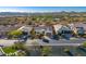 Aerial view of a luxury home community with mountain views and a lake at 17817 E Cindercone Rd, Rio Verde, AZ 85263