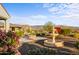 Landscaped backyard oasis featuring a water fountain and fire pit at 17817 E Cindercone Rd, Rio Verde, AZ 85263