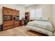 Guest bedroom with a built-in desk and wood flooring at 17817 E Cindercone Rd, Rio Verde, AZ 85263