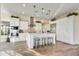 Modern white kitchen with large island and stainless steel appliances at 17817 E Cindercone Rd, Rio Verde, AZ 85263