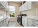 Bright laundry room with washer, dryer, and ample cabinetry at 17817 E Cindercone Rd, Rio Verde, AZ 85263