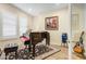 Music room with piano, guitar, and ample natural light at 17817 E Cindercone Rd, Rio Verde, AZ 85263