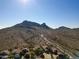 Aerial view of houses nestled against mountainside, showcasing desert landscape at 1801 E Paradise Ln, Phoenix, AZ 85022