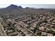 Aerial view of a neighborhood nestled against a mountain range at 1801 E Paradise Ln, Phoenix, AZ 85022