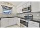 Modern kitchen with stainless steel appliances and white cabinets at 1801 E Paradise Ln, Phoenix, AZ 85022