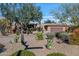 Desert landscape surrounds this one-story home with a large garage and stucco exterior at 18300 E Tonto Verde Dr, Rio Verde, AZ 85263