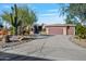 This stucco home has a three-car garage and mature desert landscaping at 18300 E Tonto Verde Dr, Rio Verde, AZ 85263