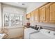 Laundry room with washer, dryer, and wood cabinets at 18300 E Tonto Verde Dr, Rio Verde, AZ 85263