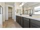 Modern bathroom with double vanity and walk-in shower at 19028 W Rose Ln, Waddell, AZ 85355